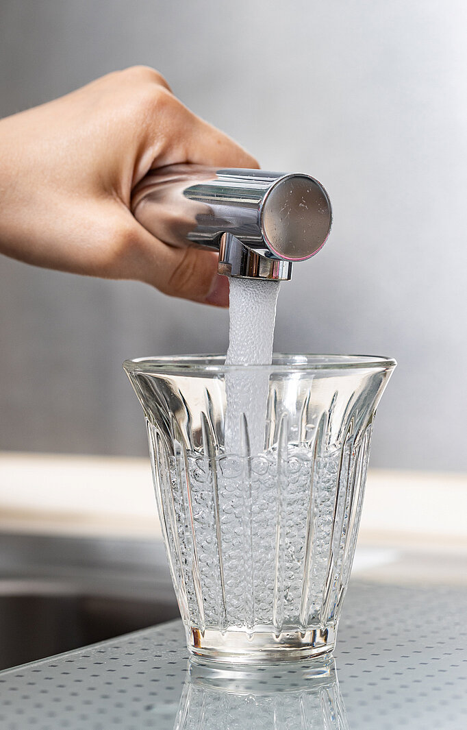 Leitungswasser wird in ein Trinkglas gefüllt